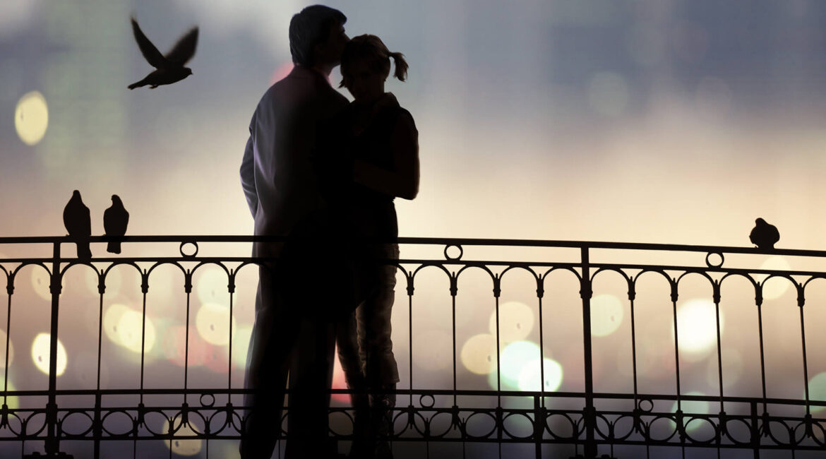 a man hugs woman on the bridge